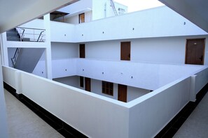 A multi-level building with balconies, staircases, and doors. - RTP RESIDENCY (Anaikkattu)