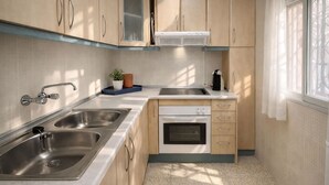 A compact kitchen with two sinks, a stove, and a dishwasher. - LA MATA BEACH · Apartment with a view in La Mata (Torrevieja) for 4 people (La Mata)