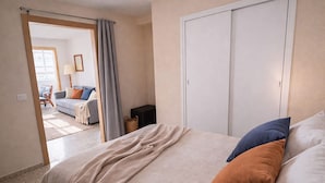 A bedroom with a bed, a wardrobe, and a view of a living area. - LA MATA BEACH · Apartment with a view in La Mata (Torrevieja) for 4 people (La Mata)