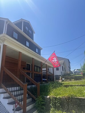 A two-story house with a porch and a staircase. - 3-bedroom house in delightful Braintree with hot tub and movie screening room (Braintree)
