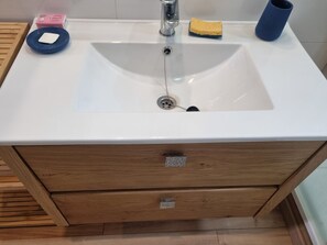 A bathroom sink with a wooden cabinet below, a soap dish, and a sponge. - L'Écrin d'Orelle Apartment – 2 Bedrooms, Mountain Views, Near Gondola (Orelle)