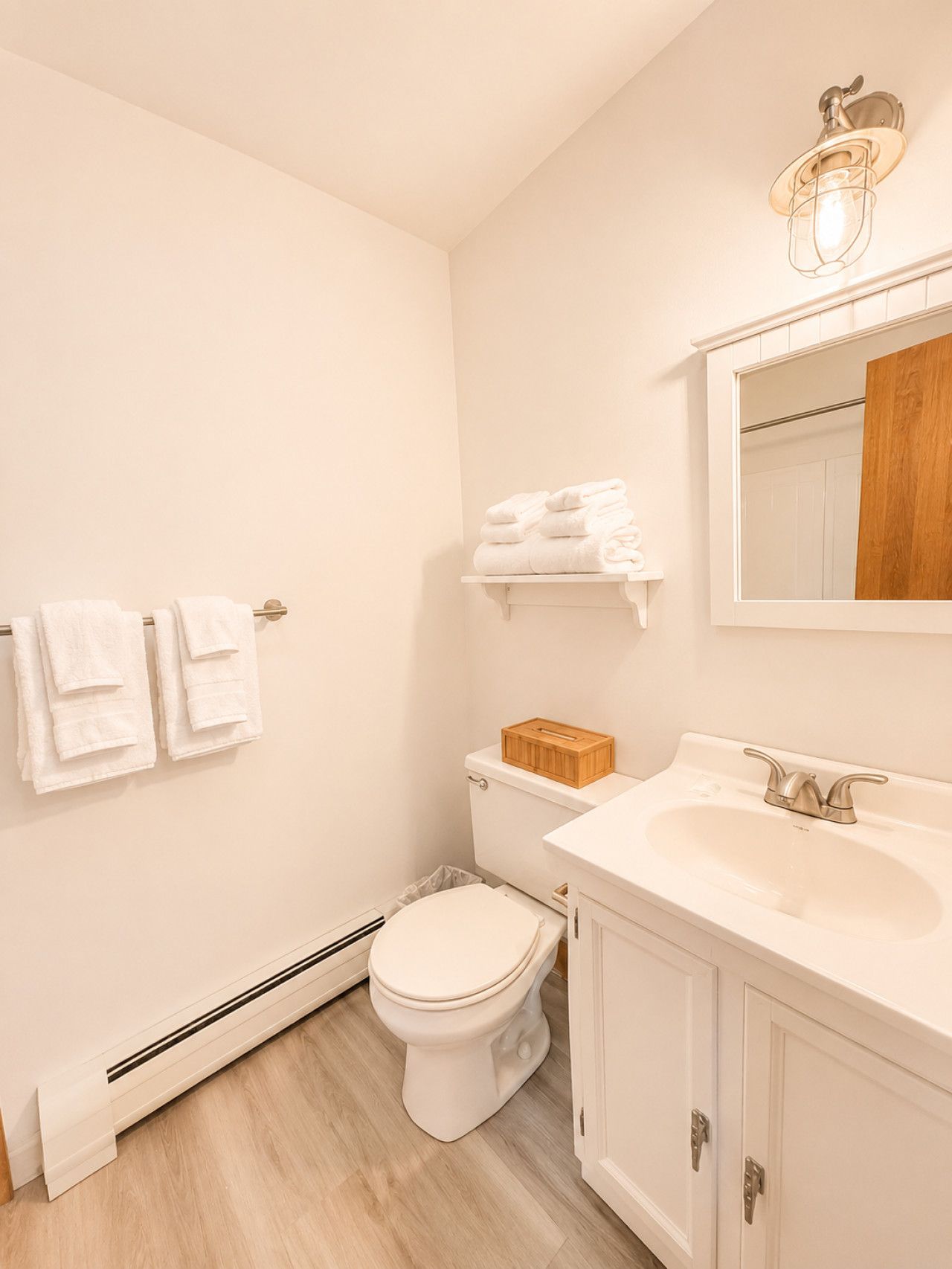 Een badkamer met toilet, wastafel en handdoekhouder.