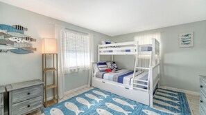 A child's bedroom with bunk beds, a fish-themed rug, and a wall with fish decorations. - Water Views | Beach | Pool | Paddle Boards (Bradenton)