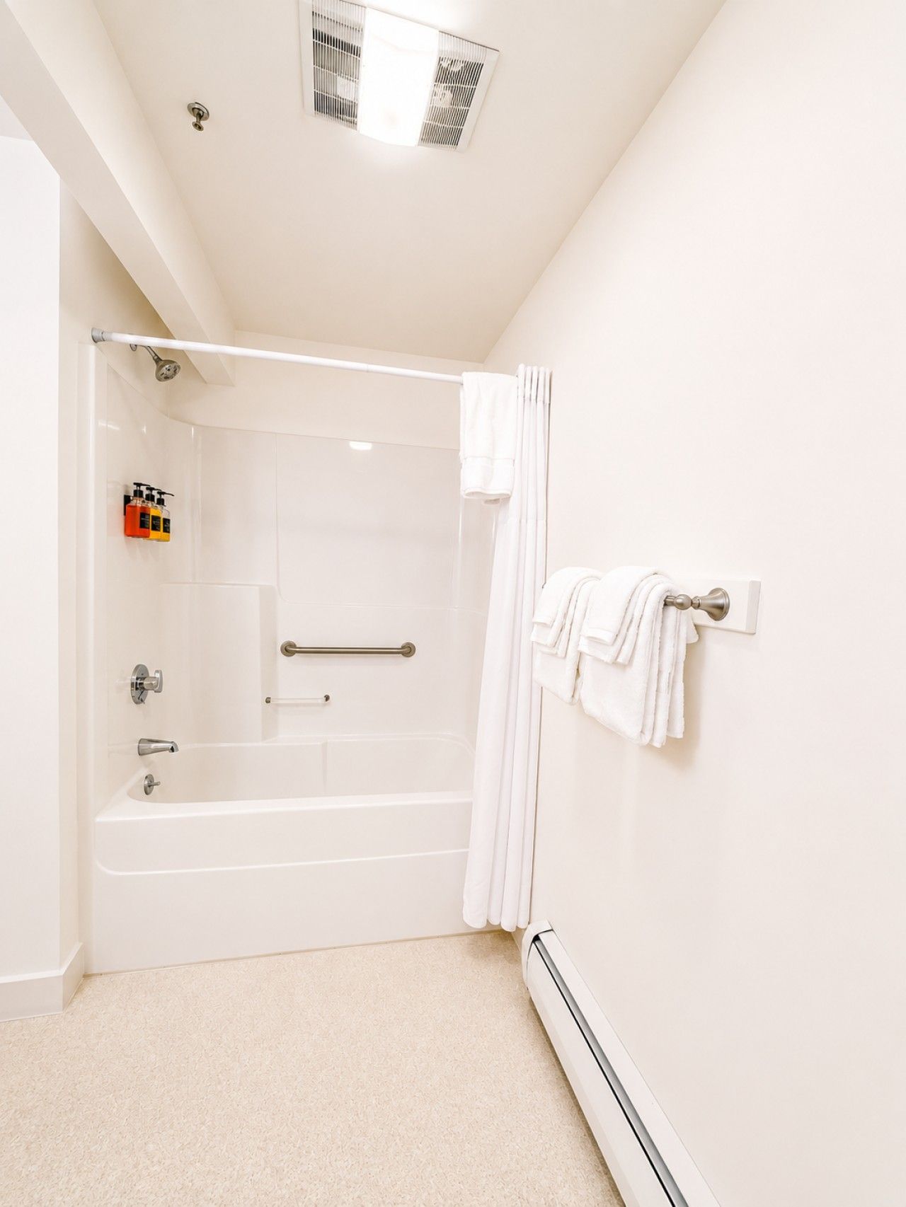 A modern bathroom with a walk-in shower, a bathtub, and a toilet.