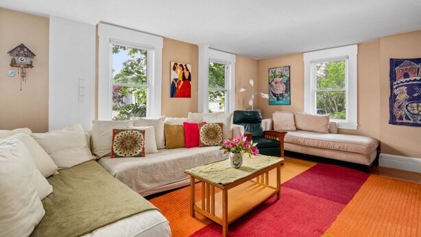 A living room with a sofa, armchairs, a coffee table, and a fireplace. - Towne Motel Camben Room #2 (Camden)