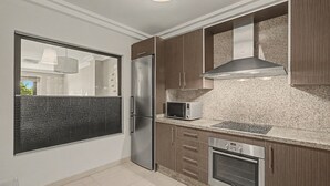 Uma cozinha moderna com eletrodomésticos de aço inoxidável, micro-ondas e forno embutido.