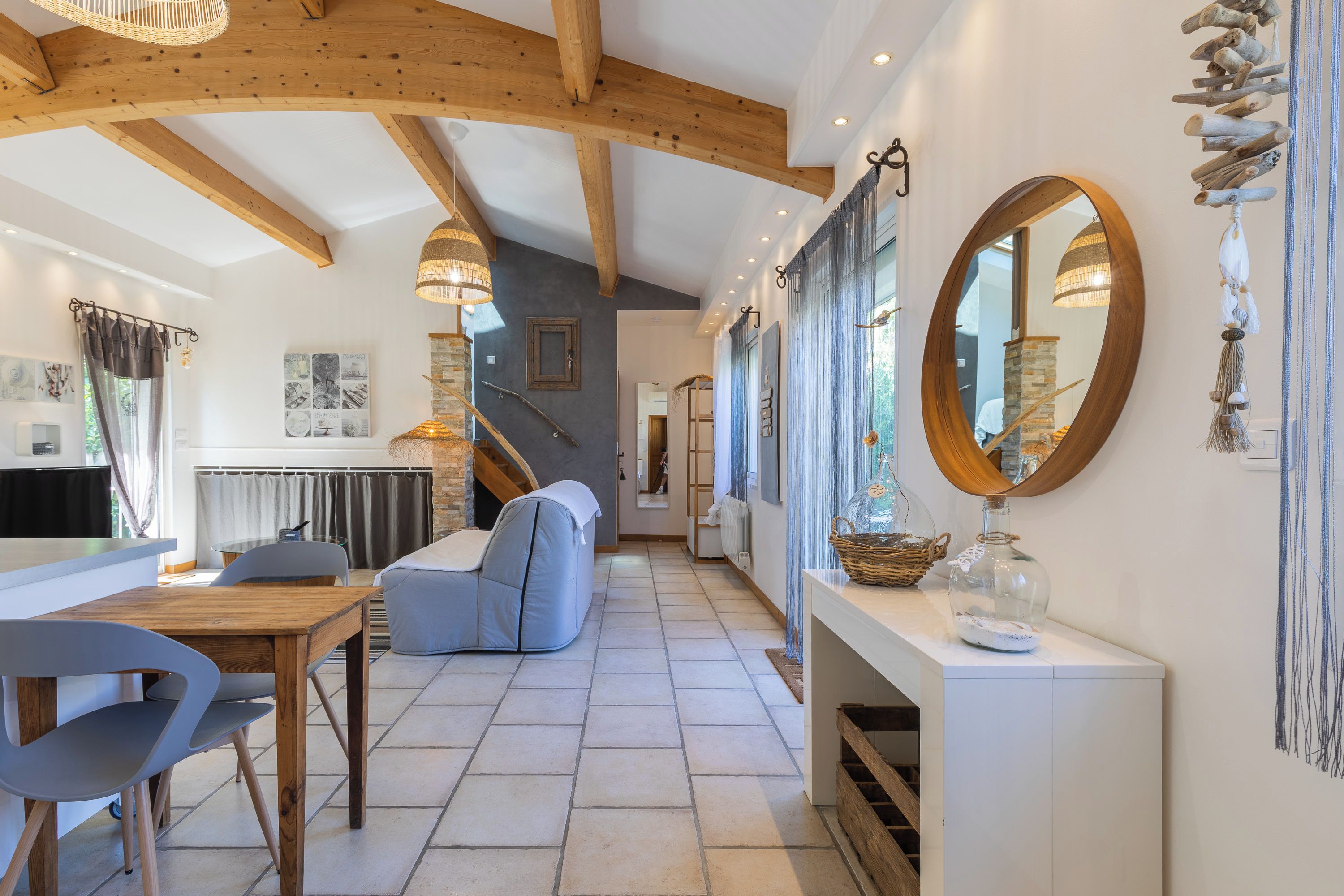 A modern interior with a dining area, a staircase, and a living space.