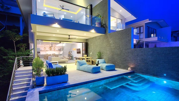 A modern two-story house with a swimming pool, outdoor seating, and a staircase leading to the upper level. - "Villa by the Bay" with panoramic view of Samrong Bay and Koh Phangan island. (Chang Wat Surat Thani)