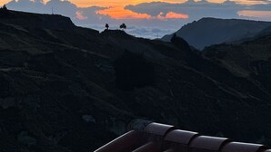 A mountainous landscape with a sunset.
