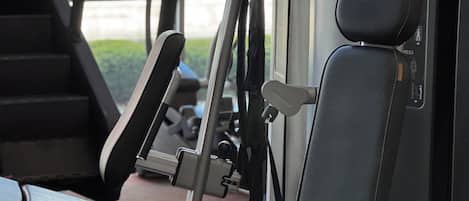 A gym with exercise equipment, including a treadmill and a weight machine.