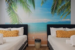 A room with two beds, a wall mural of a beach, and a trash can. - Game Room, Pool & Mickey-themed Retreat (Davenport)