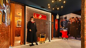 A themed interior with a brick wall, a sign reading 'Hogwarts Express', and a model train display. - Spider-man Gamer Paradise + Themed Bedrooms (Kissimmee)