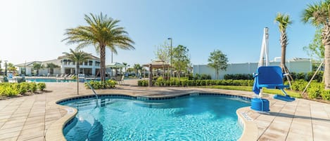 A swimming pool with a 3 ft 6 in depth, surrounded by palm trees and lounge chairs.