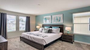 A bedroom with a bed, nightstands, and artwork on the walls. - 6BR @ Storey Lake/harry Potter & Star Wars Rooms (Kissimmee)