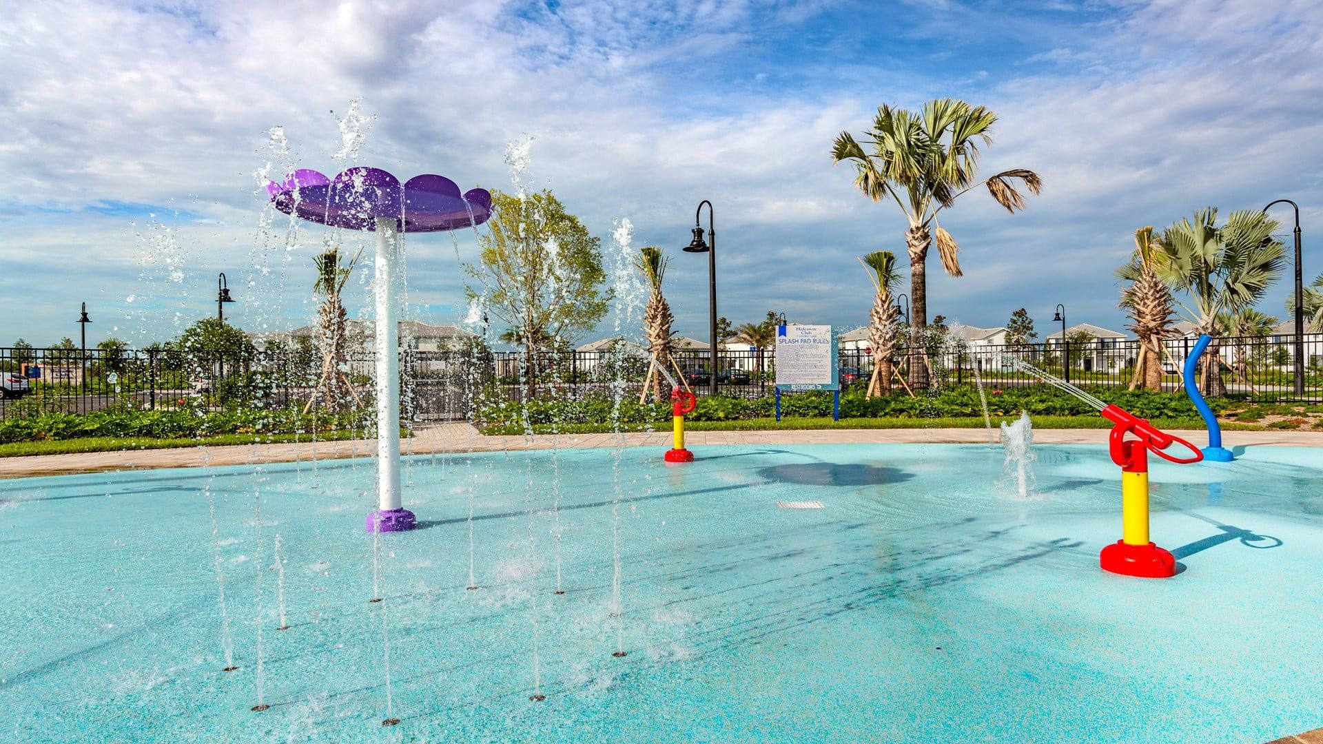 A water play area with multiple fountains and a pool.