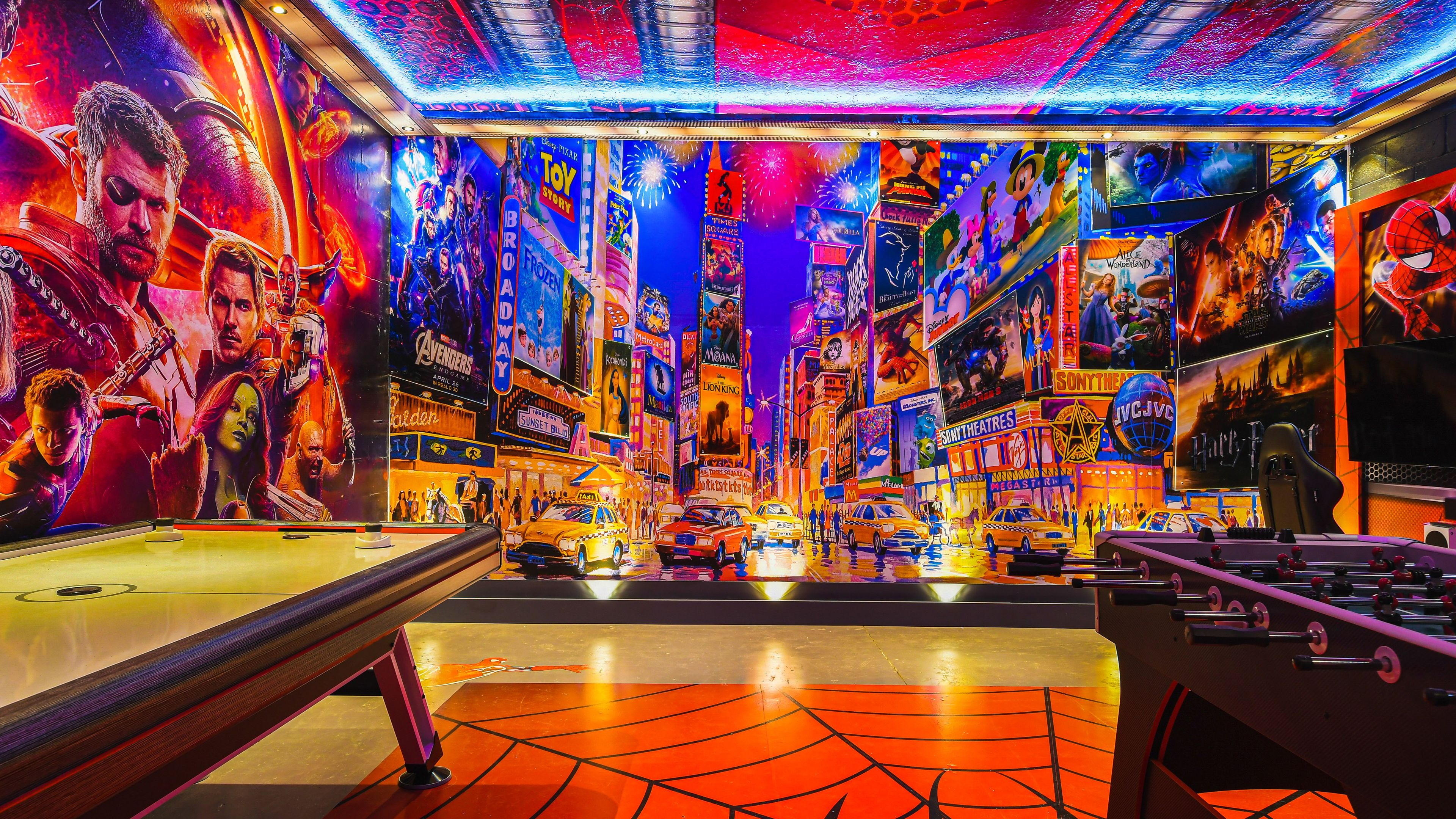 A vibrant arcade with neon lights and movie posters on the walls.