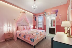 A bedroom with a canopy bed, a vanity with a mirror, and a chandelier. - Discounted 12br w Barbie Castle/dino Slide/games (Kissimmee)