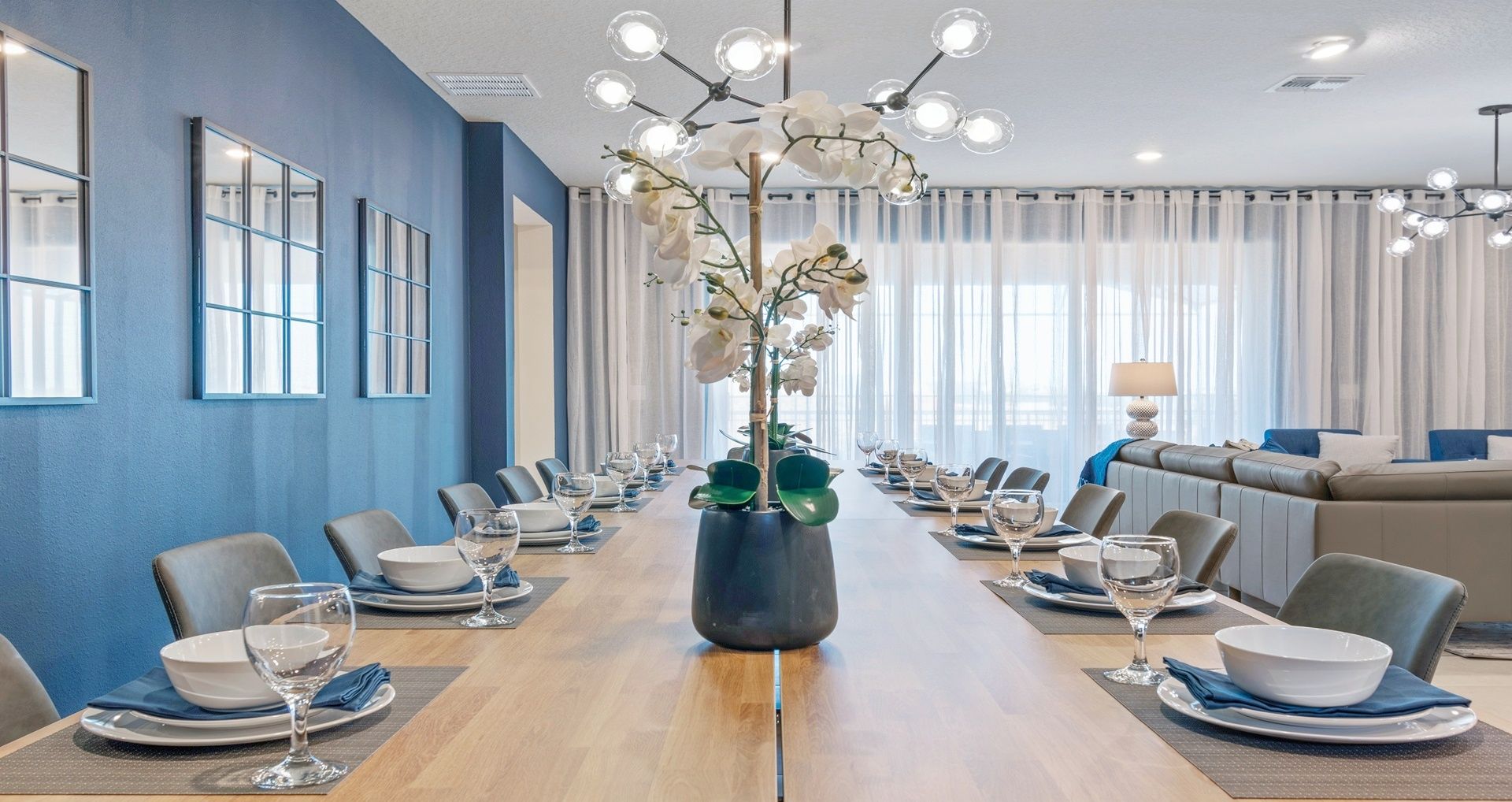 A conference room with a long table, chairs, and a central plant.