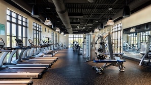 A gym with treadmills, weight machines, and free weights. - Epic Game Loft & Space-themed Theater Experience (Kissimmee)