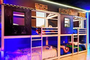 A bunk bed room with multiple beds, each with a unique design and color scheme. - Luxury Storey Lake Villa With Starry Theater (Kissimmee)