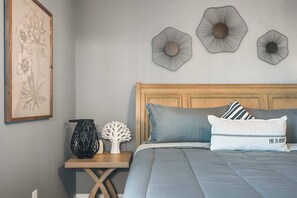 A bedroom with a wooden headboard, a bed with grey bedding, a framed botanical illustration, and three wall-mounted decorative items. - 8BR @ Windsor Island/star Wars Gameroom/themed BR (Davenport)