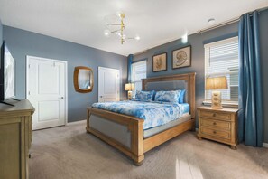 A bedroom with a bed, bedside tables, a dresser, a mirror, and a ceiling light fixture. - 8BR @ Windsor Island/star Wars Gameroom/themed BR (Davenport)
