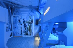 A futuristic room with a metallic robot figure, a bed, and a window. - Best Rate 10br/frozen/space BR & Marvel Gameroom (Davenport)