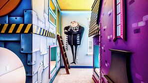 A narrow hallway with colorful walls and a character mural. - Mermaid & Snow White-themed Escape Near Disney (Davenport)