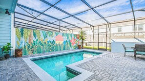 A pool area with a glass enclosure, a tiled floor, and a colorful mural on the wall. - Vibrant Villa With Tropical Mural & Fun Bunk Beds (Davenport)