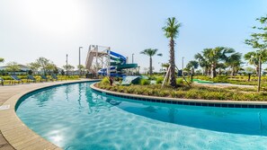 A swimming pool with a water slide, palm trees, and lounge chairs. - Star Wars & Encanto Bunk Rooms + Pool @ Storeylake (Kissimmee)