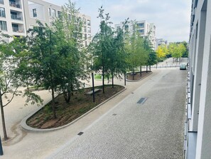 A street with trees and modern buildings.