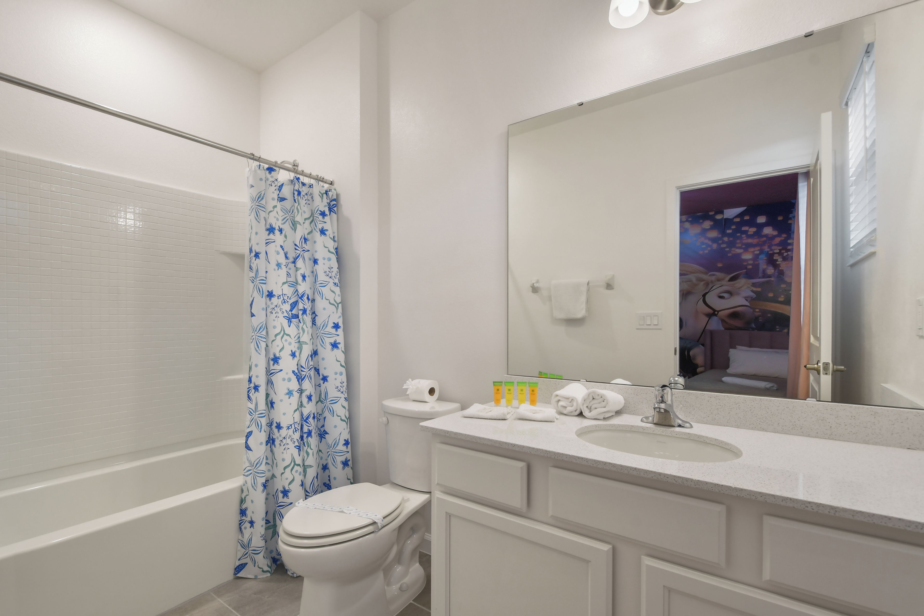 A bathroom with a shower, toilet, and sink.
