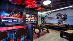 A gaming room with multiple monitors, a foosball table, and Star Wars-themed decorations. - Minions, Star Wars, & Frozen-themed Family Retreat (Kissimmee)