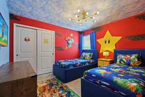 A bedroom with two beds, a ceiling fan, and a star decoration on the wall. - Grand Marvel & Star Wars Villa Windsor Island (Davenport)