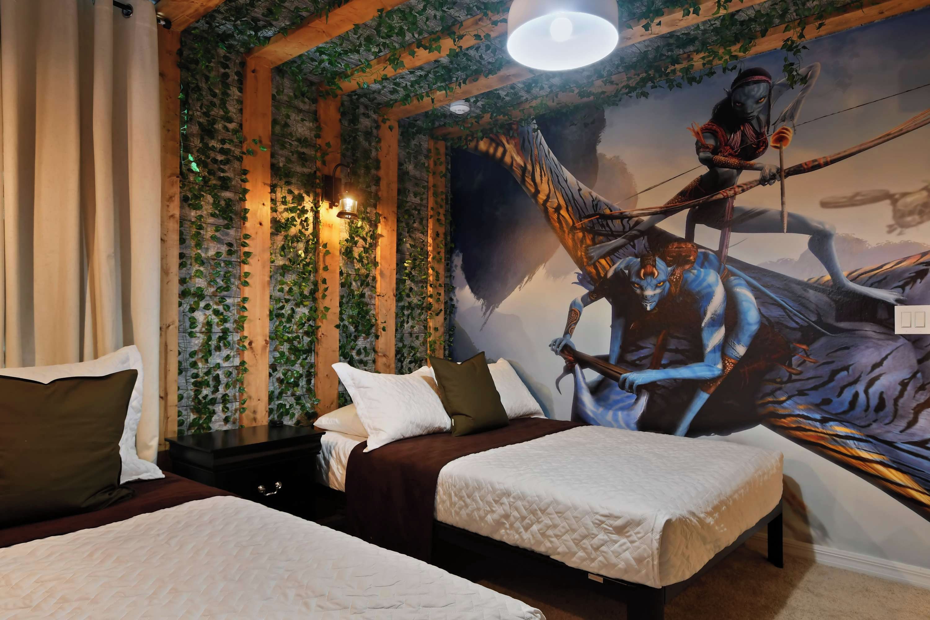 A bedroom with two beds, a mural of a mythical creature, and a wooden ceiling with greenery.