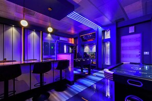 A bar area with stools, a foosball table, and a pool table. - 10br Windsor Epic Themed Villa Private Pool (Davenport)