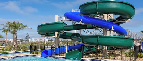 A water park with multiple slides and a pool.