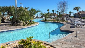 A swimming pool with a curved design, surrounded by palm trees and a no entry sign. - Enchanting Moana & Hogwarts Rooms Close to Parks (Davenport)