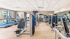 A gym with treadmills, weight machines, and free weights. - Lakeview Home w/ Mario Game Room & Themed Bedrooms (Kissimmee)
