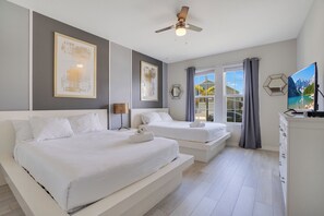 A hotel room with two beds, a ceiling fan, a window with curtains, and a flat-screen TV. - 9br/star Wars/harrypotter Themed Rooms/pool/disney (Davenport)