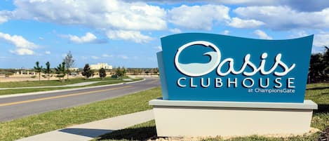 A sign for Oasis Clubhouse at ChampionsGate.