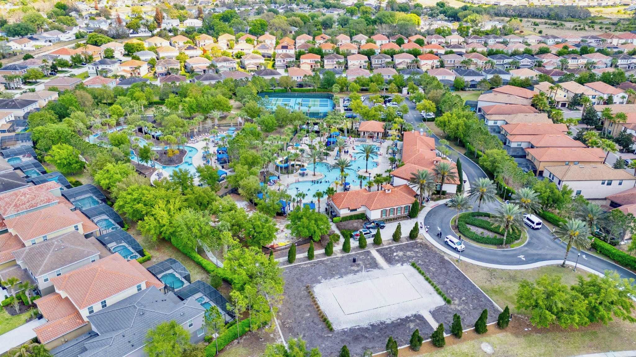 A residential area with a central swimming pool surrounded by houses and greenery.