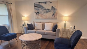 A living room with a sofa, two armchairs, a coffee table, and two lamps. - Updated 2BR | Private Deck | Near Decatur and EAV (Decatur)