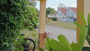 A sign for Noah's Bed & Breakfast with a view of a residential area and a parked bicycle. - Noah Bed&Breakfast 3Private Room NEWHOME Quiet Place to Stay 14mins PPS Airport (Puerto Princesa City)