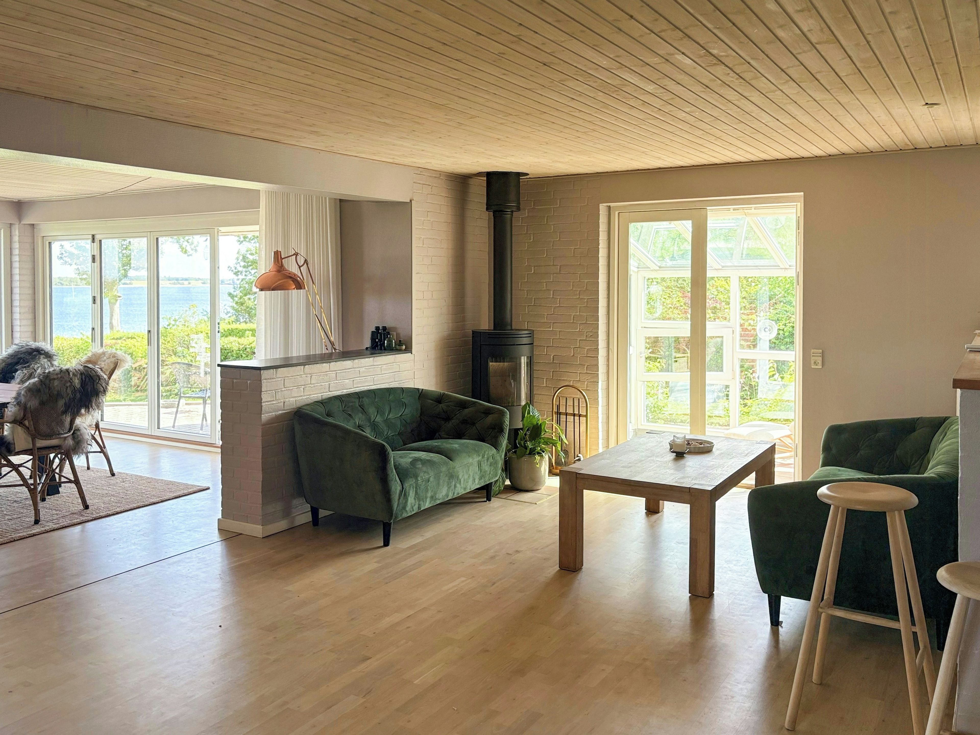 A spacious living area with a fireplace, a dining table, and a sofa.