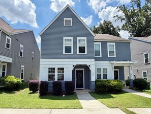A two-story residential building with a central entrance, a covered porch, and a visible address number. - Fully Furnished Retreat In The Heart Of Charlotte (Charlotte)