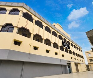 A hotel with a modern facade, multiple windows, and a sign indicating it is a hotel. - Deluxe Room Shree Ram Residency (Cuttack)