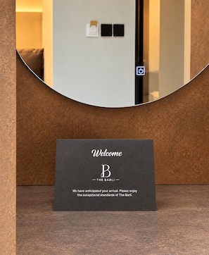 A reception area with a welcome sign for 'The Barli' hotel. - The Barli Hotel and Apartments (Abuja)