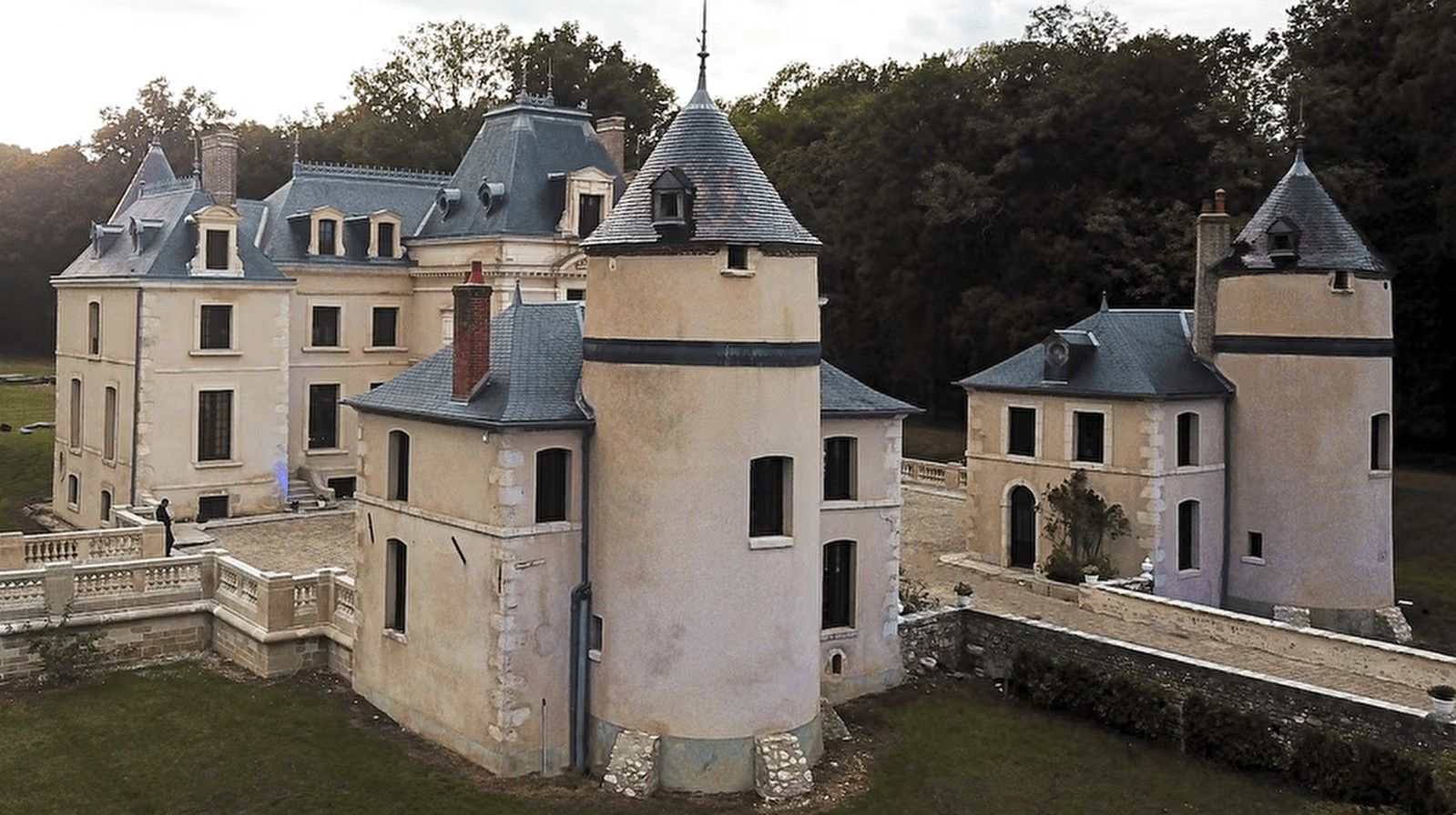 Un château doté de nombreuses tours, d’une cour centrale et d’un fossé qui l’entoure.