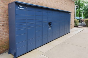 A large blue storage unit with a 'hub' logo, a small window, and a keypad. - Modern Studio with Queen Bed in Raleigh (Raleigh)